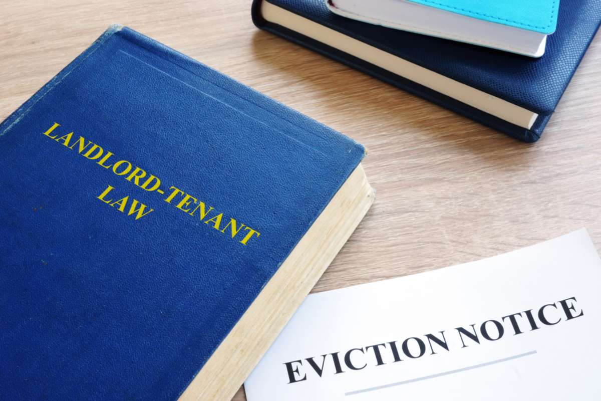 Landlord-Tenant Law and eviction notice on a desk