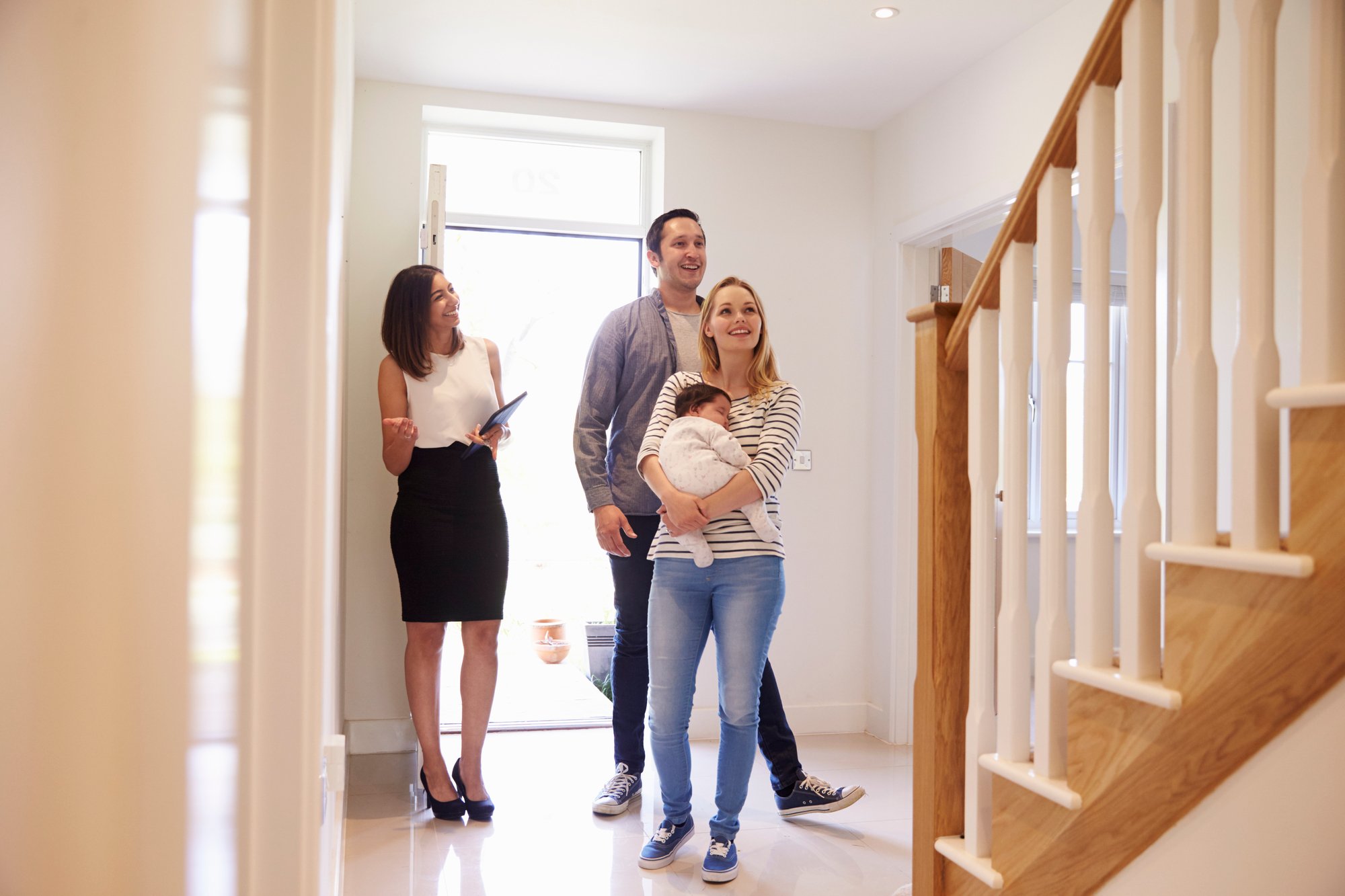 Realtor Showing Family Around Property For Sale