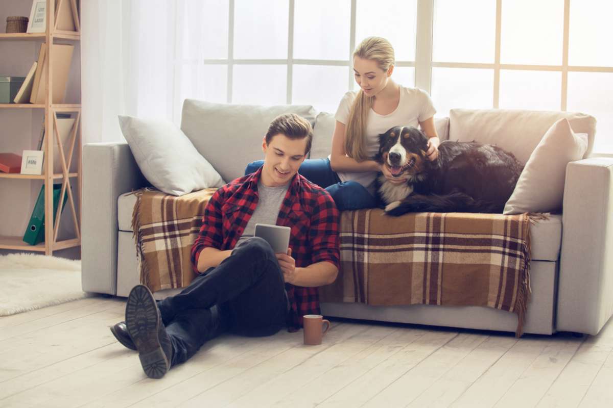 Young people with dog at home leisure