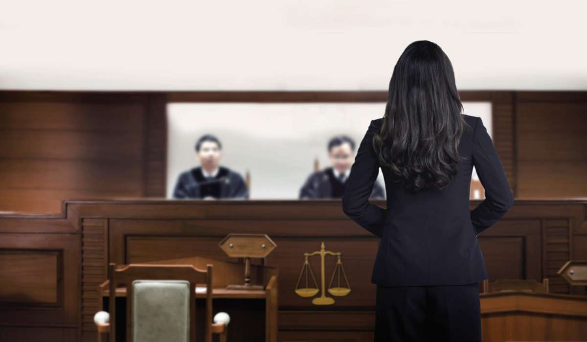 attorney woman on courtroom talking to magistrate in court box