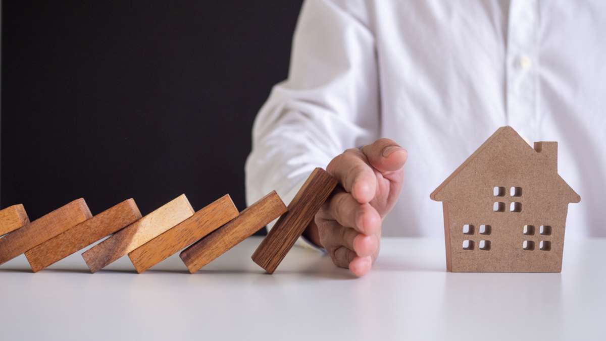 insurance with hands protect a house (R) (S)