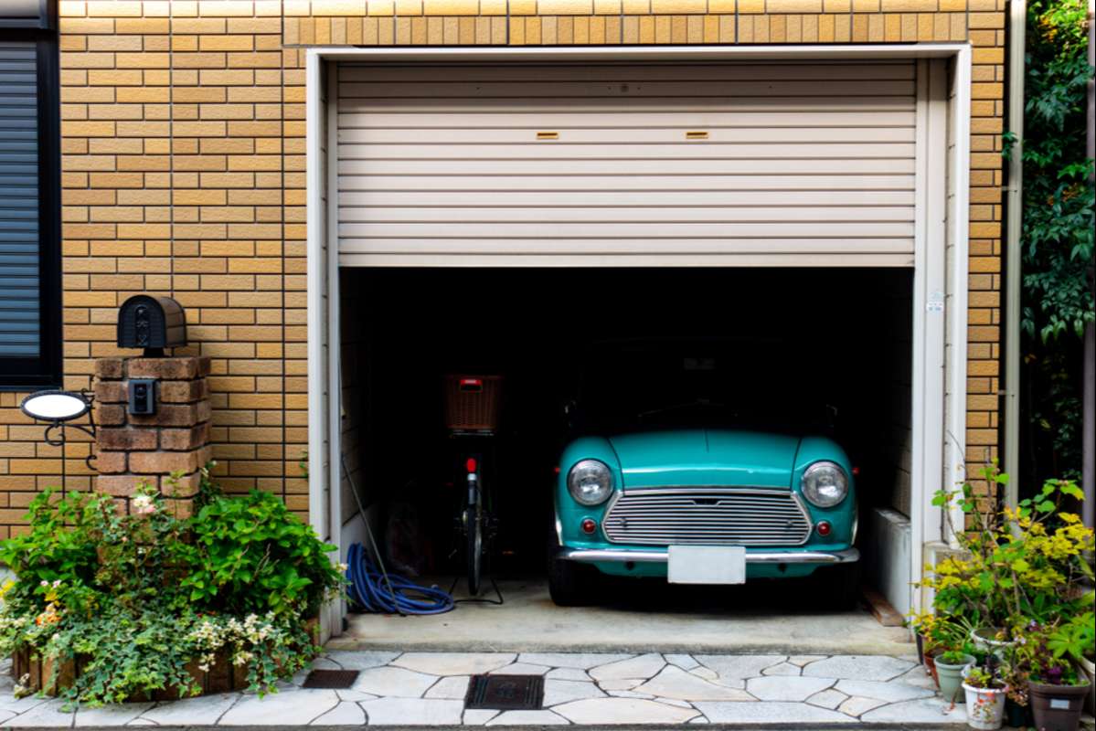 turquoise small vintage car parked in a dark private garage (R) (S)